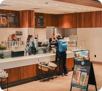 Customer ordering at Starbucks counter in the MAC