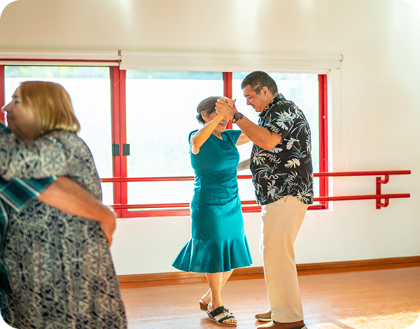 Couple dances together in a group dance class.