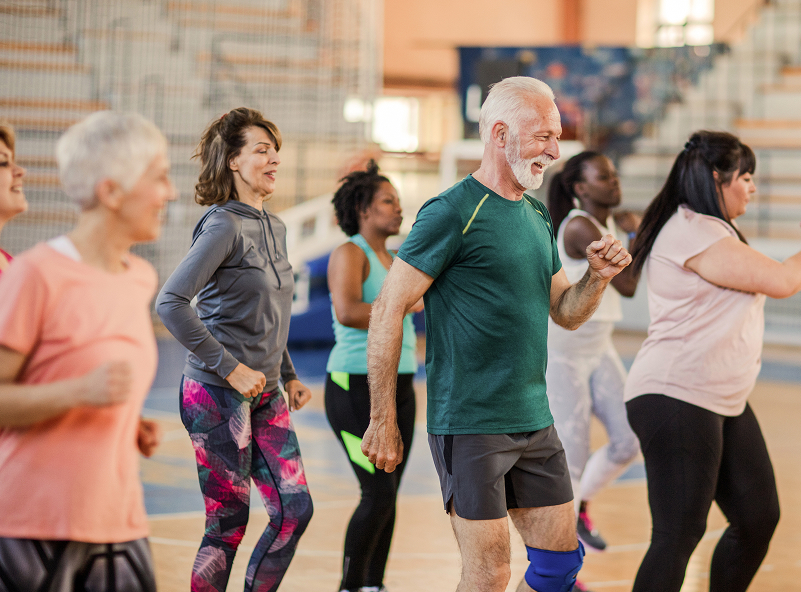 Group of adults engaging in a dance fitness class