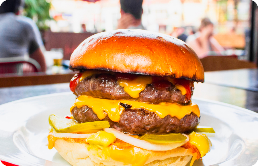 A juicy cheeseburger served outside.