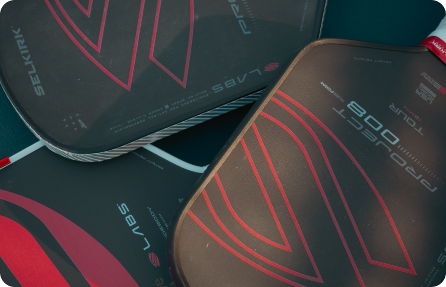 Pickleball paddles in a pile